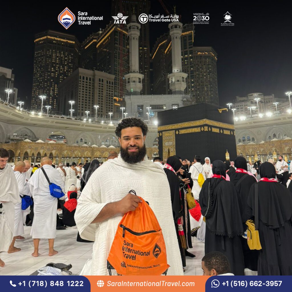 Brother stands infront of Kaaba during Umrah